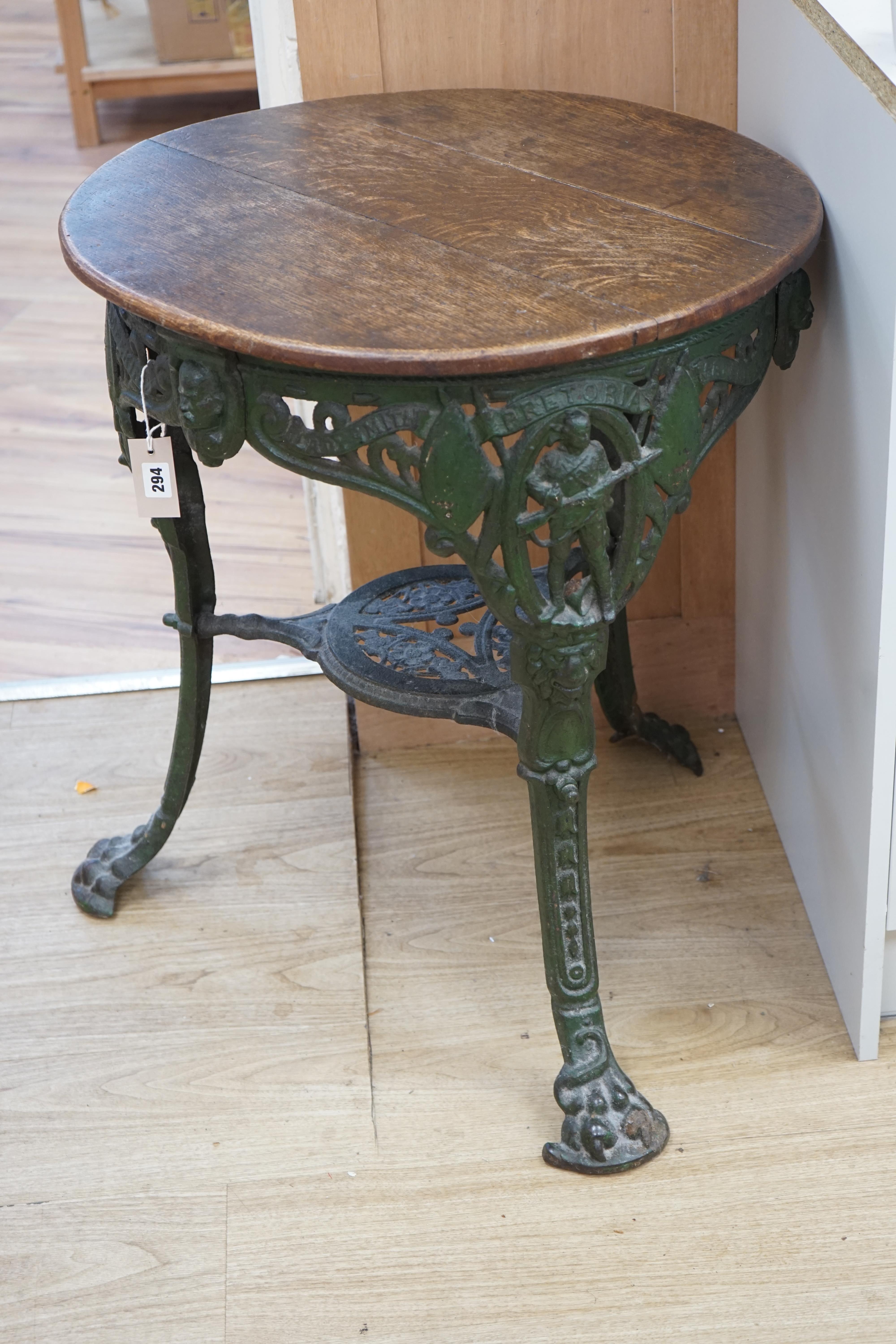 A rare early 20th century Boer War commemorative cast iron pub table, decorated with standing soldiers beneath Ladysmith, Pretoria and Mafeking scrolls, legs bearing registered number 364112, the circular oak top 62cm di